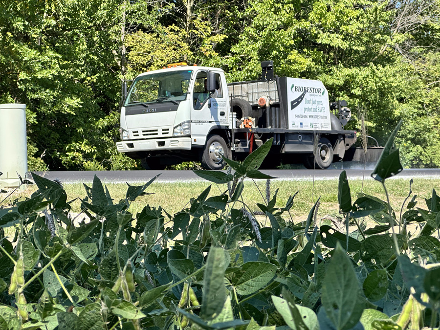 Spray truck applying BIORESTOR beside a Kentucky soybean field